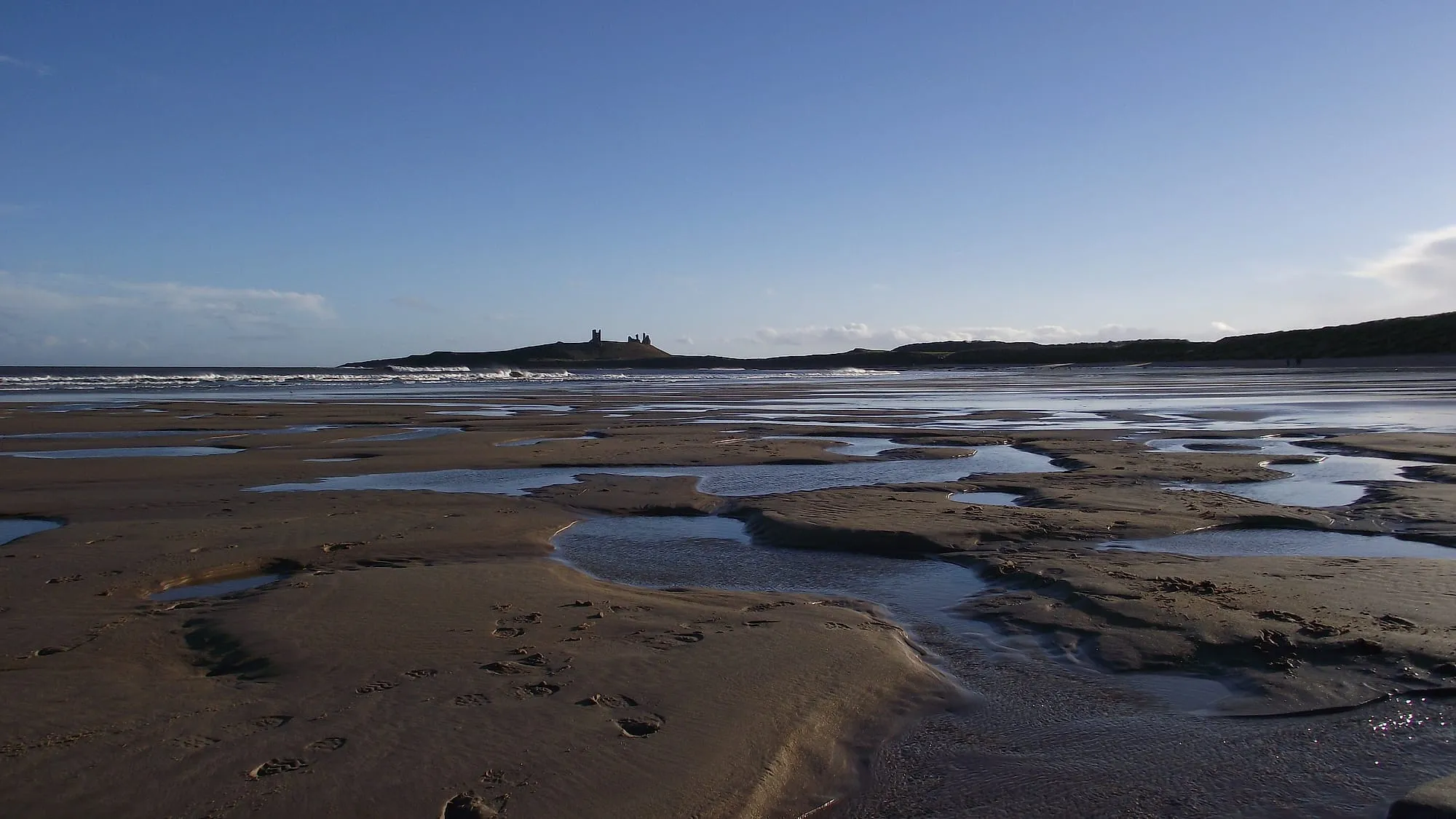 Distant ruins of Dunstanburgh Castle, NE England
